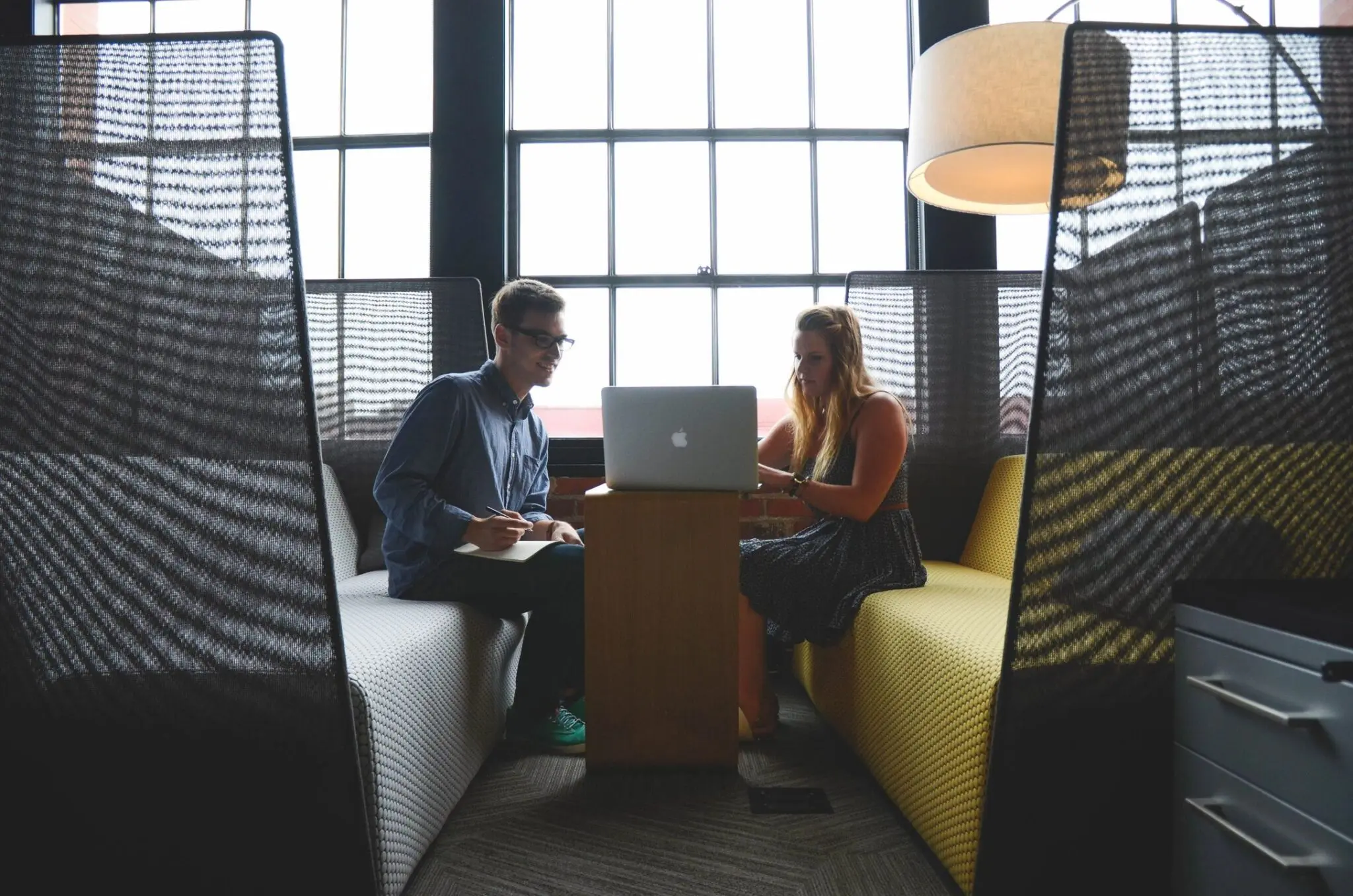 Two people working at a laptop.