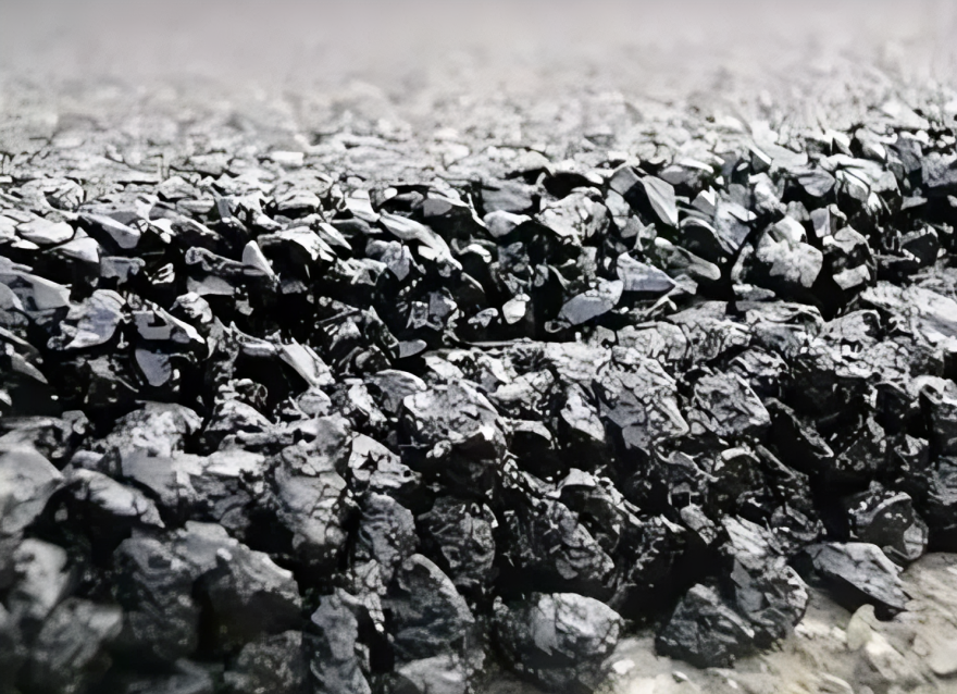Close-up of black coal pieces on ground.