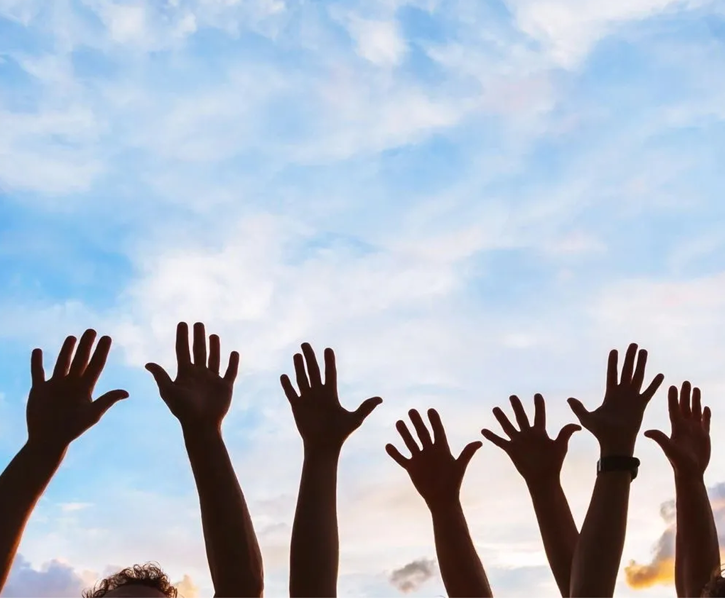 Raised hands against a blue sky background.