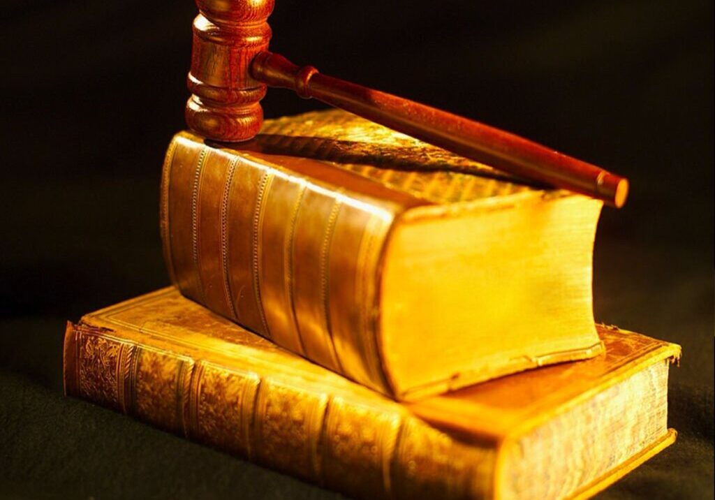 A gavel resting on two stacked, old legal books.