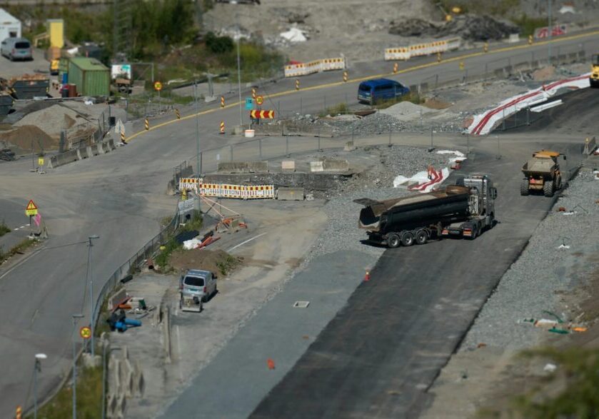 Road construction site with trucks and equipment.